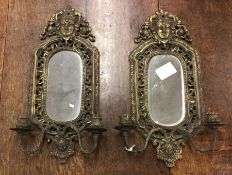 A pair of gilded brass wall sconces. Est. £100 - £