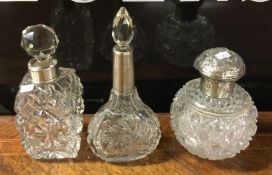 Three silver mounted scent bottles. Est. £30 - £50