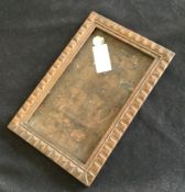 A picture frame modelled from old shell cases. Est