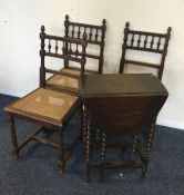 A set of four oak chairs together with a table. Es