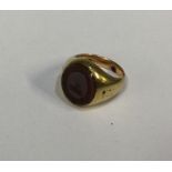 A 9 carat signet ring inset with cornelian. Approx