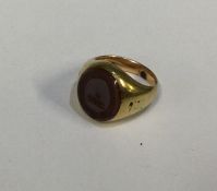 A 9 carat signet ring inset with cornelian. Approx