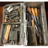 A metal box containing old tools. Est. £10 - £20.