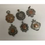 A group of six silver watch chain medallions. Est.