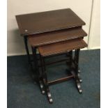 A mahogany nest of three tables. Est. £30 - £40.