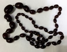 A graduated string of amber beads. Est. £50 - £80.