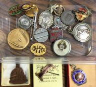 A small tub of badges and football medals. Est. £1