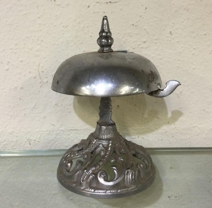 A stylish chrome counter bell. Est. £20 - £30.