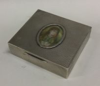 An engine turned silver cigar box with hand painte