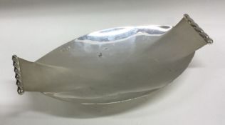 A silver fruit dish with spiral decorated handles.