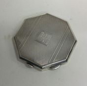 A heavy octagonal engine turned silver compact. Bi