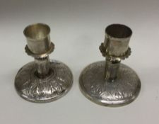 A pair of heavy Continental silver taper sticks wi