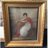 A gilt framed picture of a lady with a lyre