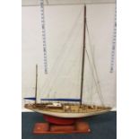 A small wooden pond yacht. Est. £20 - £30.