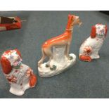 A pair of Staffordshire dogs together with a Staff