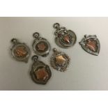 A group of six silver watch chain medallions. Est.