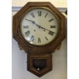 An Edwardian oak wall clock with white enamelled d