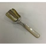 A silver and MOP caddy spoon. Birmingham 1906. App
