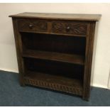 An oak two drawer bookcase. Est. £50 - £80.