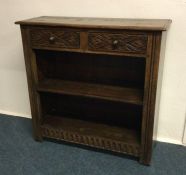 An oak two drawer bookcase. Est. £50 - £80.