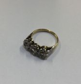 An 18 carat gold three stone ring. Approx. 3 grams
