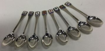An attractive set of eight silver and enamelled co