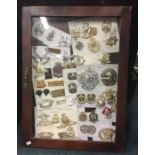 A framed and glazed display cabinet containing cap