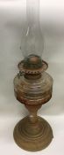 A copper mounted oil lamp with glass reservoir. Es