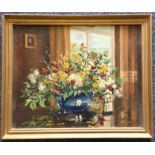 A framed oil on board depicting a still life of fl