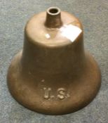 A bronze bell marked 'US', probably from a World W
