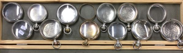 A large collection of pocket watch cases. Est. £30