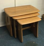 ERCOL: A nest of three tables. Est. £60 - £80.
