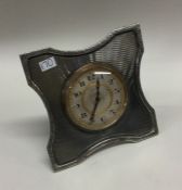 A large heavy silver desk clock with engine turned