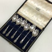 A boxed set of six scroll decorated silver teaspoo