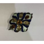 A stylish silver and enamelled buckle inset with y