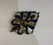 A stylish silver and enamelled buckle inset with y