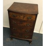 A walnut bow front chest of four drawers. Est. £30
