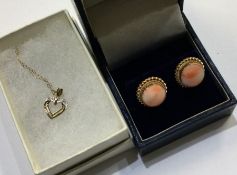 A pair of coral and gold earrings together with a