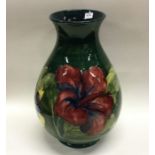 MOORCROFT: A pottery vase of typical form in green