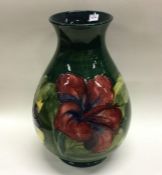 MOORCROFT: A pottery vase of typical form in green