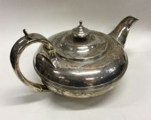 A large circular silver teapot with crested armori