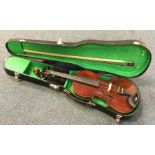 An old cased violin. Est. £30 - £40.