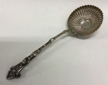 A large Victorian silver sifter spoon with figural