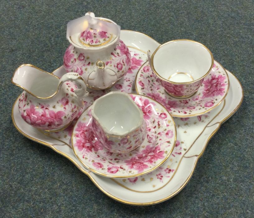 A decorative miniature doll's tea service. Est. £1