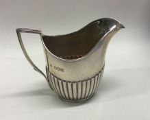 An Edwardian silver half fluted cream jug. London.