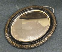 A small oval gilt mirror. est. £20 - £30.