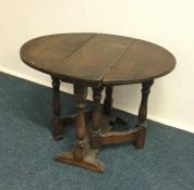 A small oak rustic drop leaf table. Est. £20 - £30