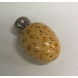 A silver mounted scent bottle set with an ostrich egg. B