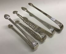 A selection of four silver sugar tongs. Various da