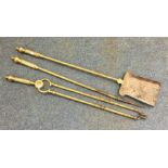 A brass three piece companion set. Est. £30 - £50.